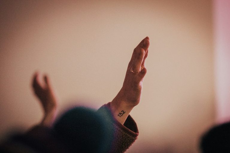 person in black long sleeve shirt showing right hand